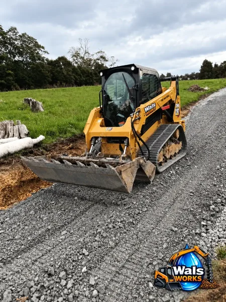 tracked loader on gravel driveway